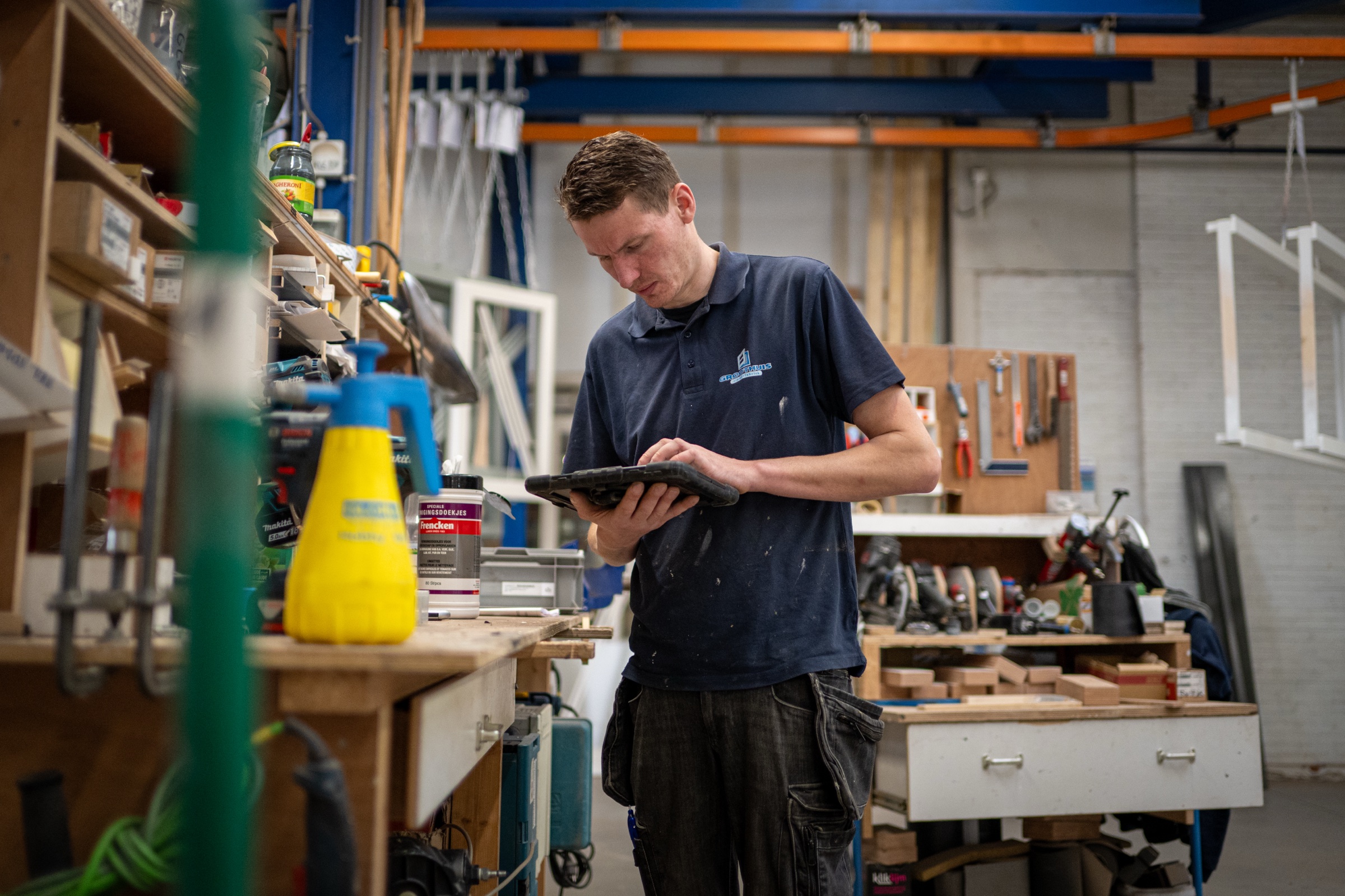 Medewerker met iPad aan werkbank